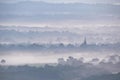 Glorious landscape image of layers of mist rolling over South Downs National Park English countryside during misty Summer sunrise Royalty Free Stock Photo