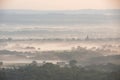 Glorious landscape image of layers of mist rolling over South Downs National Park English countryside during misty Summer sunrise Royalty Free Stock Photo