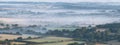 Glorious landscape image of layers of mist rolling over South Downs National Park English countryside during misty Summer sunrise Royalty Free Stock Photo