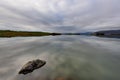 Stunning landscape at Lake Thveit in Iceland. wonder of nature with the sky and the mountain reflected in a mirror of water. Beaut Royalty Free Stock Photo