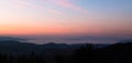 Stunning landscape panorama from Bulgarian mountains with a sea of fog and distance mountains during sunrise. Royalty Free Stock Photo