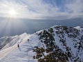 Stunning landscape of snow-capped mountains with a group of climbers got to the top of it.