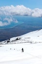 Stunning landscape taken from Mount Etna, Sicily, Italy. Hikers on the way down from the volcano. Snow on the mountain. Sicilian Royalty Free Stock Photo