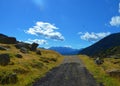 Stunning landscape view with an unpaved walkway leading to mountains