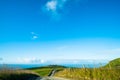 The stunning landscape of the way in a rural area in New Zealand. Gravel road among green grassland with blue sky. I Royalty Free Stock Photo