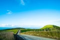 The stunning landscape of the way in a rural area in New Zealand. Gravel road among green grassland with blue sky. I Royalty Free Stock Photo