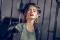 Stunning languid woman in leather outfit having red lips