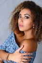 Stunning latin woman with curly hair posing in professional studio, latinoamerican woman work for model agency