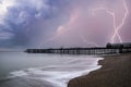 Stunning Lightning storm landscape over pier under construction and development in remote location