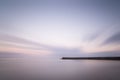 Stunning long exposure landscape lighthouse at sunset with calm