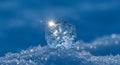 Illuminated snowflake crystal resting on fresh snow Royalty Free Stock Photo