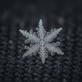 Intricate Snowflake Macro: Crystal Geometry on Dark Fabric Royalty Free Stock Photo