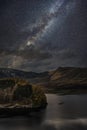 Stunning majestic digital composite landscape of Milky Way over Hawes Water in Lake District