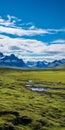 Vibrant Landscape Photography: Green Pasture With Majestic Mountain Backdrop Royalty Free Stock Photo