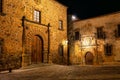 Stunning medieval stone buildings and palaces at night in Caceres, Spain
