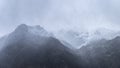 Stunning moody dramatic Winter landscape image of snowcapped Y Garn mountain in Snowdonia