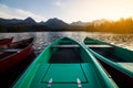 Stunning mountain lake with colorful wooden boat.