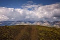 Stunning mountain landscape. Thunderstorm front over the mountain range, sun`s rays shine through fluffy clouds. Beautiful sky. Royalty Free Stock Photo