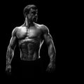 Stunning muscular young men bodybuilder looking behind