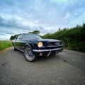 Stunning 1966 Mustang CoupÃÂ© beneath cloudy skies