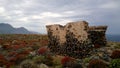 Stunning mystical view of the destroyed remains of walls on the island Gramvousa. Bright red bushes on the rocky rocky ter