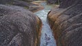 Close up view, swift river flowing with mountain rock formations