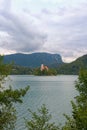 Stunning nature landscape of Bled Lake with St. Marys Church of Assumption on small island. Natural frame form green leaves Royalty Free Stock Photo