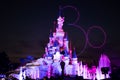 Stunning night shot of the iconic Disneyland castle lit up with vibrant colors