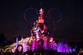 Stunning night shot of the iconic Disneyland castle lit up with vibrant colors