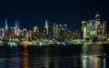 Stunning night skyline of New York City, illuminated by vibrant lights.