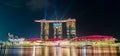 Stunning night-time view of Marina Bay in Singapore, illuminated by the lights