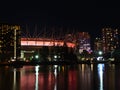 Stunning night view of False Creek bay, Vancouver downtown with illuminated BC Place Stadium reflected in the calm water.