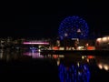 Stunning night view of False Creek bay with Vancouver Science World and BC Place Stadium mirrored in the calm water.