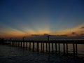 Stunning orange yellow after glow on dark blue sunset sky over the bridge to the sea Royalty Free Stock Photo