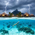 Split View of Tropical Overwater Bungalows during Storm with Woman Swimming Underwater among Stingrays Royalty Free Stock Photo
