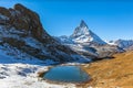 Stunning panorama view of the famous Matterhorn and peak of Swiss Pennine Alps with beautiful Riffelsee lake in foreground on