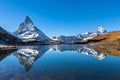 Stunning panorama view of the famous Matterhorn and Weisshorn peak of Swiss Pennine Alps with beautiful reflection in Riffelsee