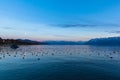 Stunning panorama view of Lake Leman Lake Geneva at dusk in autumn in Lausanne, with beautiful snow covered French Alps mountain Royalty Free Stock Photo