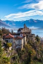 Stunning panorama view of Madonna del Sasso church above Locarno city on cliff with Lake Maggiore, snow covered Swiss Alps