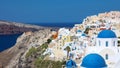 Stunning panoramic view of Santorini island with white houses and blue domes on famous Greek resort Oia, Greece, Europe. Royalty Free Stock Photo