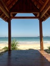 a sturdy wooden pavilion located on the edge of a beautiful beach