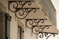 Stunning perspective of a building with decorative ironwork brackets in Saint Jean de Luz, France