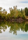 Stunning photo of fall foliage reflected on a lake with a glass like mirror water surface Royalty Free Stock Photo