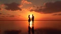 Sunset Embrace: Young Couples Silhouetted on the Beach Royalty Free Stock Photo