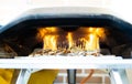 Stunning photograph of inside a fiery oven. On fire inside you make a homemade pizza