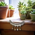 Elegant Silver Necklace & Bohemian Accessories on Rustic Display Shelf