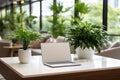 Sleek Modern Laptop on Polished Wood Desk in Well-Lit Office Room Royalty Free Stock Photo