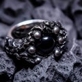 A stunning piece of jewelry with a ring composed of lustrous white pearls and midnight black pearls