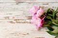 Stunning pink peonies on white light rustic wooden background. Copy space, floral frame. Vintage, haze looking. Royalty Free Stock Photo