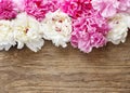 Stunning pink peonies, yellow carnations and roses on rustic woo Royalty Free Stock Photo